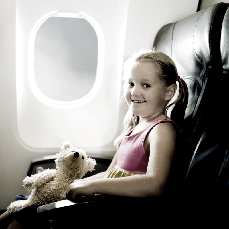 Child In Airplane On Vacation Min