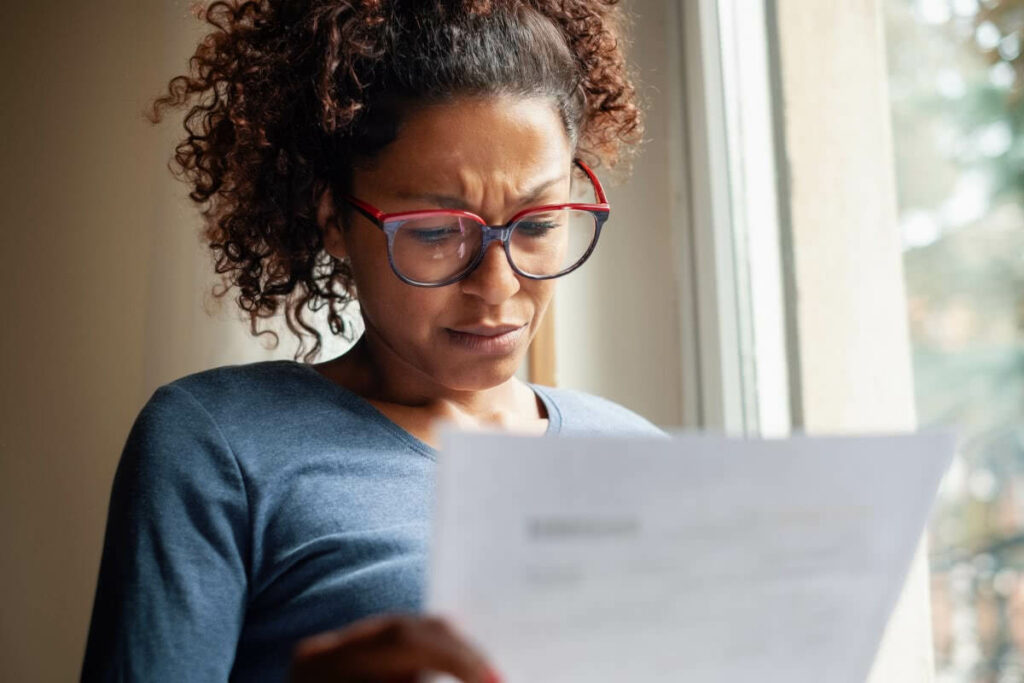 Worried Woman Reviewing Expensive Divorce Bill from Lawyer