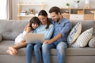 Family using Laptop on Couch