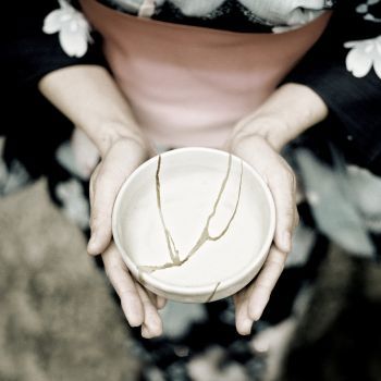 a lady holding kintsugi bowl